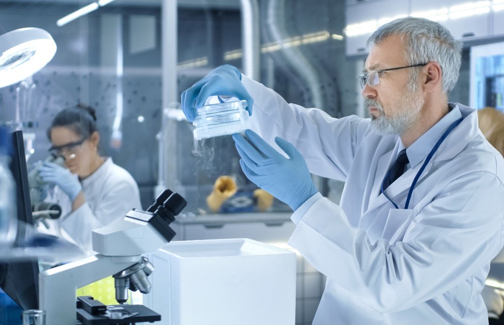 Pharmaceutical scientist verifying labeled inventory inside a temperature-mapped lab freezer
